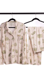 Beige womens toile pajama set with green patterns on hangers against a white background from oyster and arrow