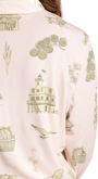 Close-up of a toile pajama fabric with green illustrations on a white background from oyster and arrow