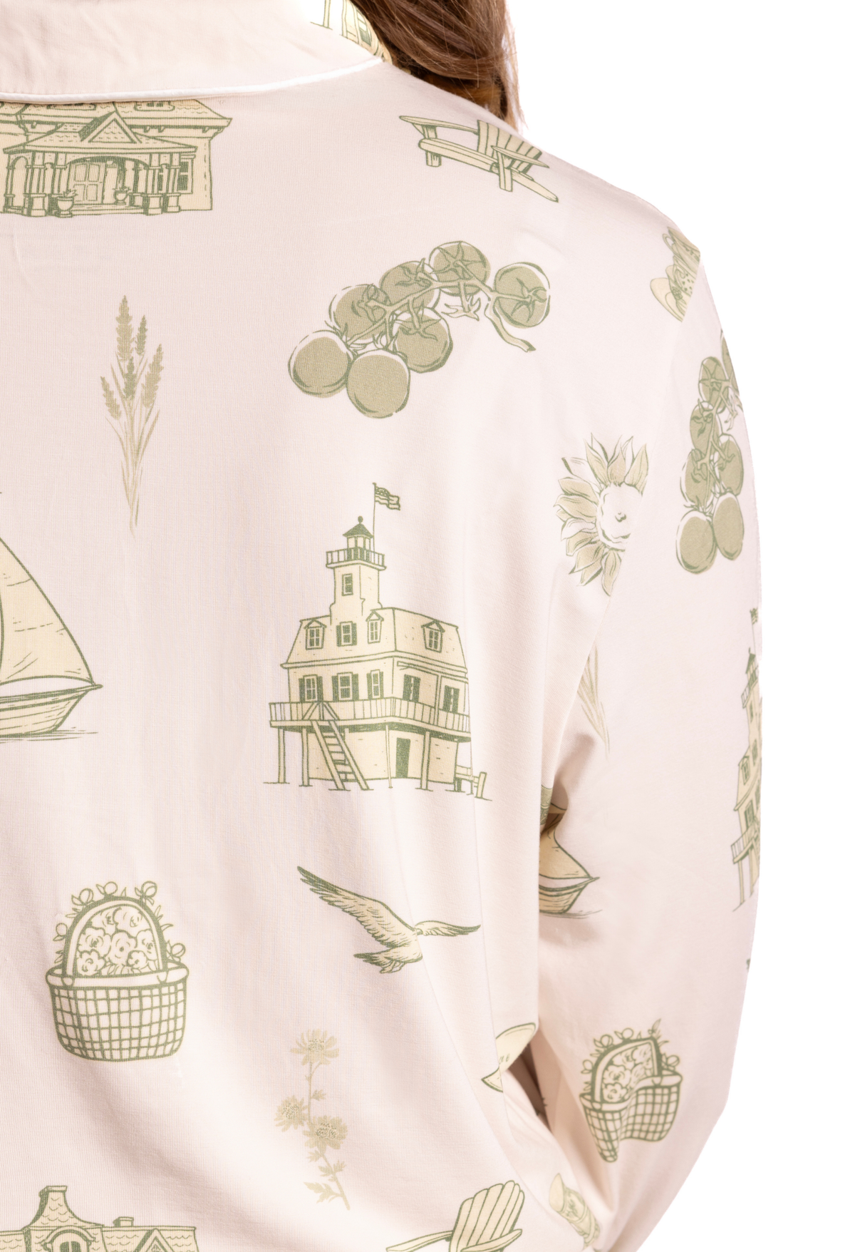 Close-up of a toile pajama fabric with green illustrations on a white background from oyster and arrow