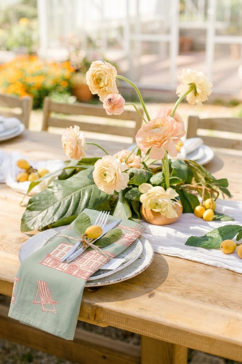 Table setting with floral centerpiece and outdoor background