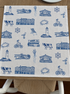 Oyster and Arrow Northport linen napkin featuring a blue and white Cow Harbor toile print with Eaton’s Neck Lighthouse and local Long Island landmarks