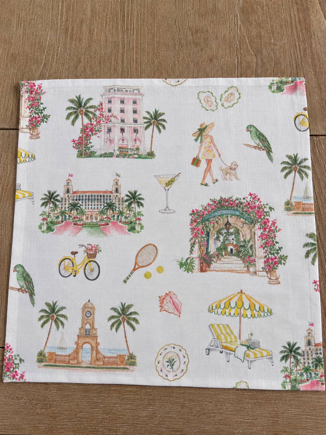 Oyster and Arrow Palm Beach linen napkin with colorful hand-illustrated Worth Avenue Clock Tower, The Breakers, Colony Hotel and Via Parigi motifs