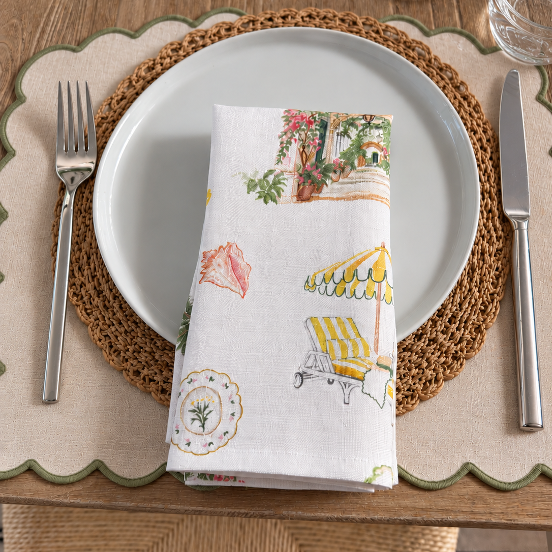 Folded Palm Beach linen dinner napkin featuring colorful coastal Florida illustrations