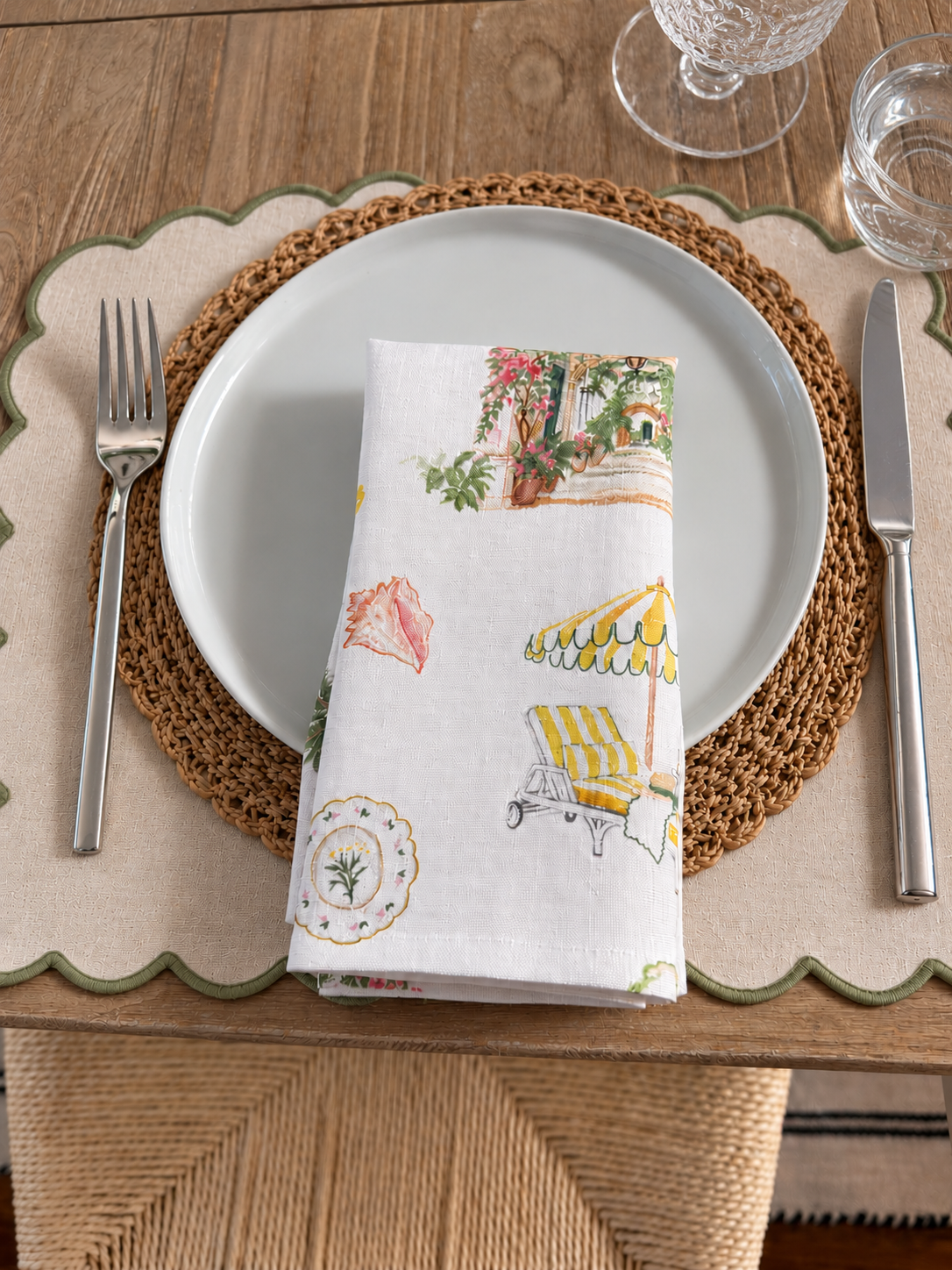 Folded Palm Beach linen dinner napkin featuring colorful coastal Florida illustrations