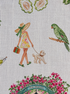 Close-up of Palm Beach linen napkin featuring a 60s inspired lady walking a poodle and a green parrot in a colorfully illustrated print.