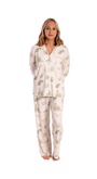 Woman wearing a white  oyster and arrow pajama set with green floral toile on a white background