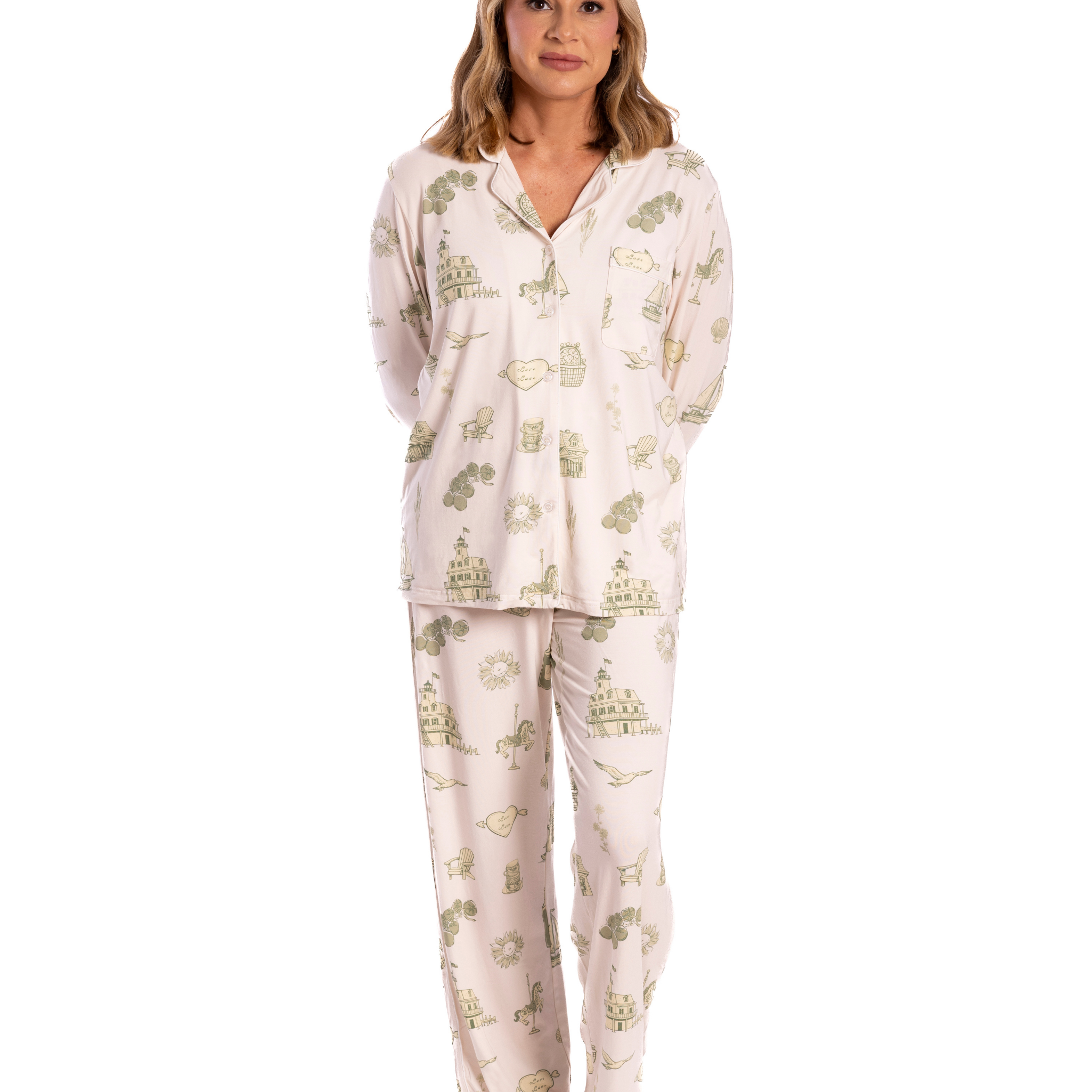 Woman wearing a white  oyster and arrow pajama set with green floral toile on a white background