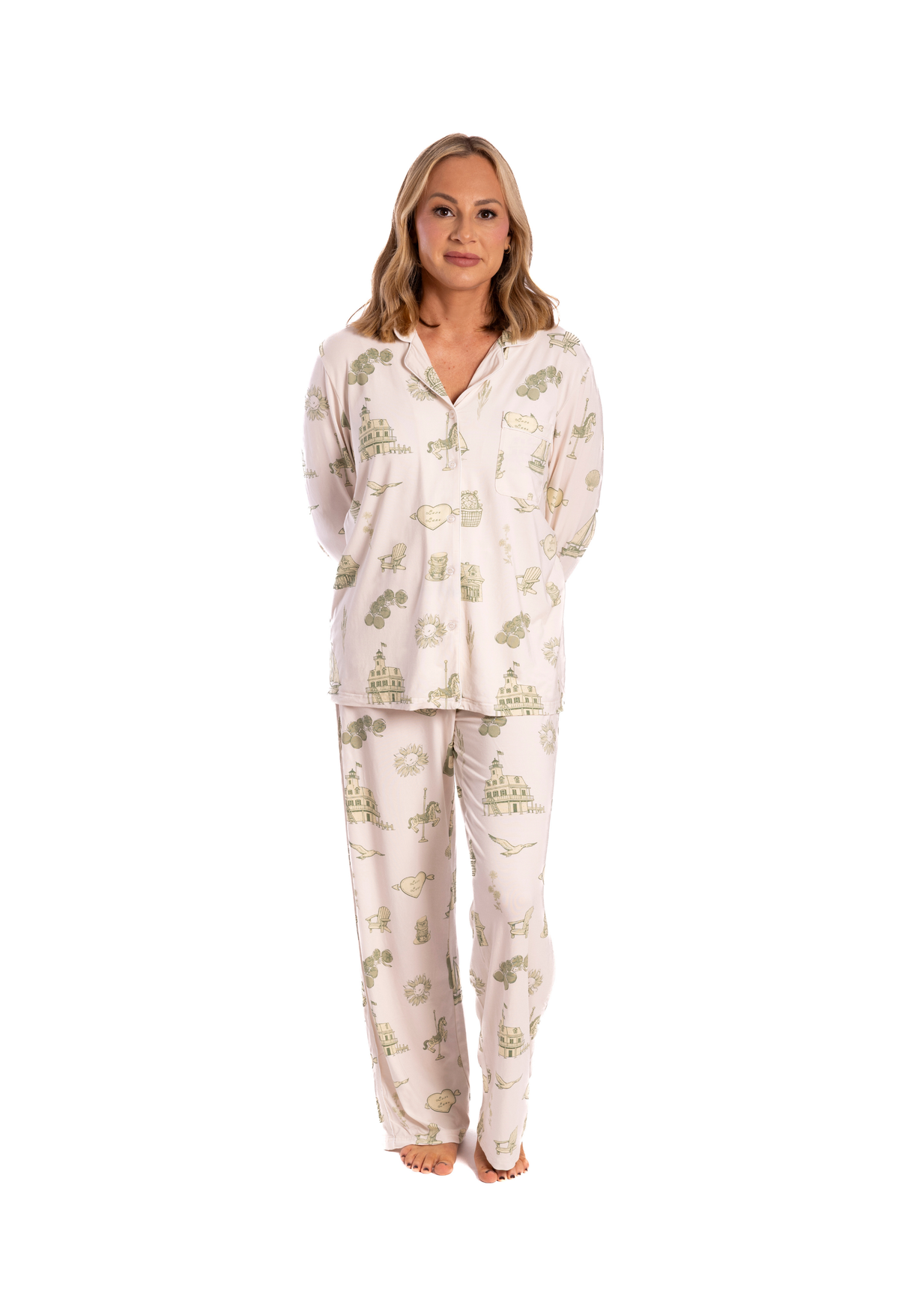 Woman wearing a white  oyster and arrow pajama set with green floral toile on a white background