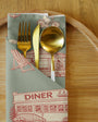 Napkin with fork, knife, and spoon holder on a wooden surface