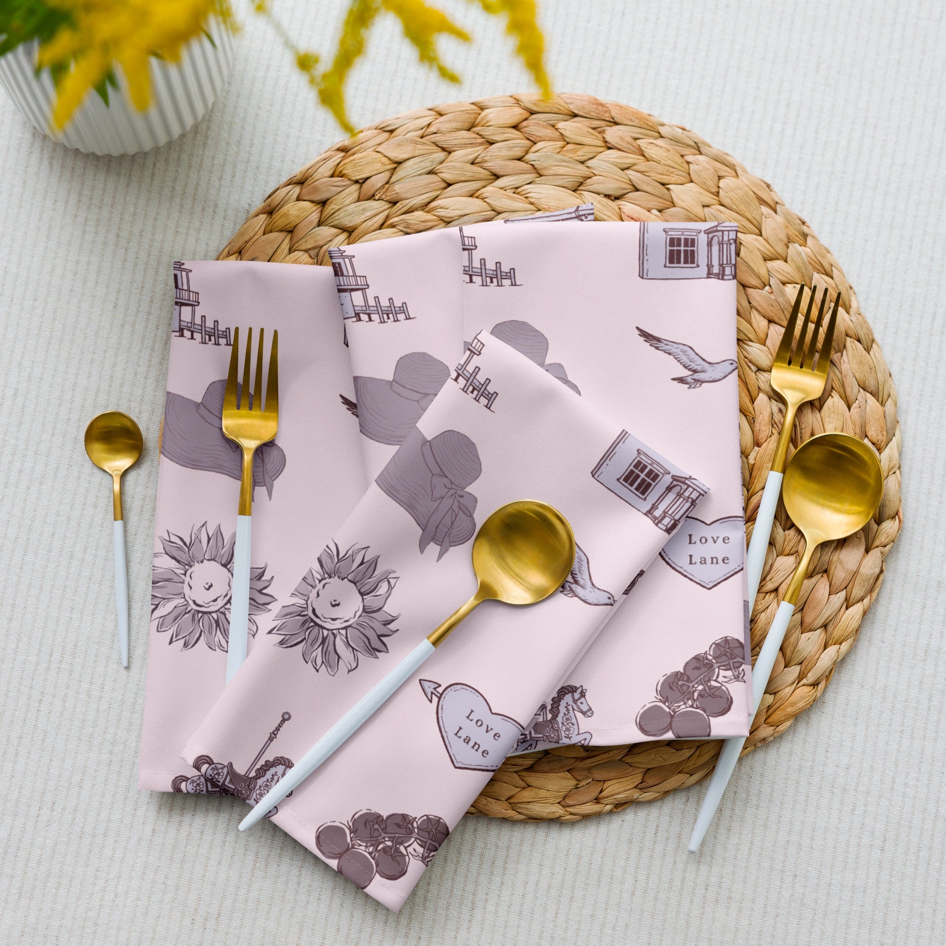 Set of patterned napkins on a woven placemat with cutlery